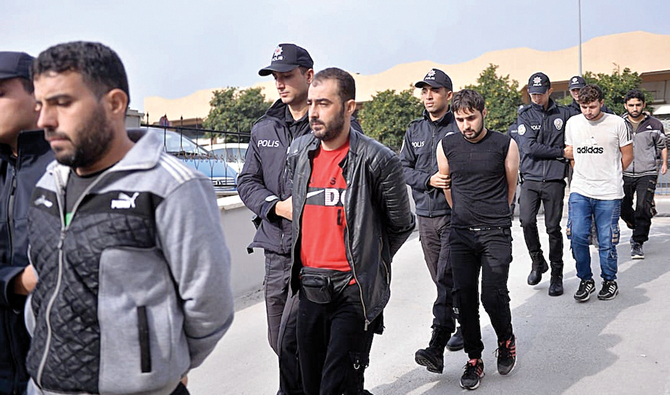 Suspected Daesh-linked men being taken into custody after they were captured in an operation carried out by Turkish security, in Mersin. (AFP/File)