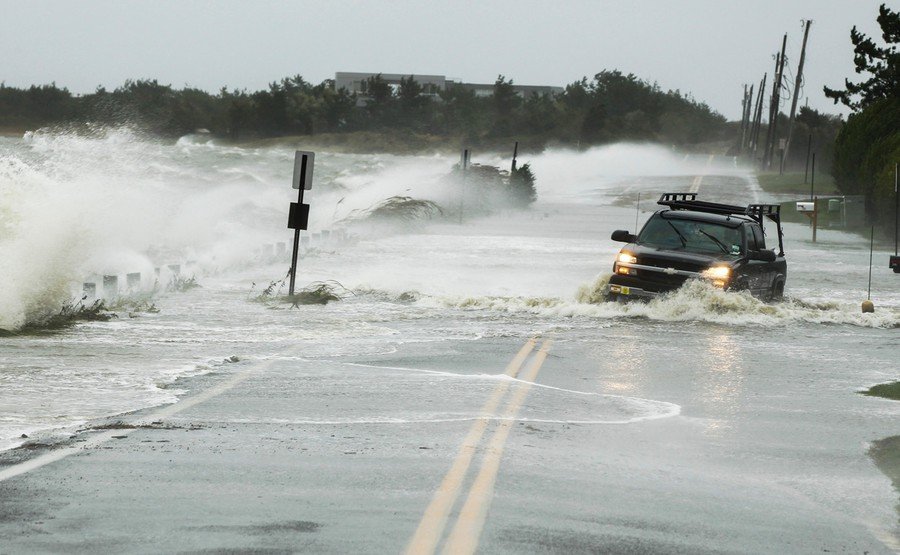 A truck drives through water pushed over a road by Hurricane Sandy in Southampton, New York, October 29, 2012. (Reuters)