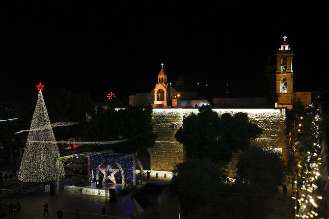 Christmas tree is lit outside the Church of the Nativity, traditionally believed by Christians to be the birthplace of Jesus Christ in the West Bank city of Bethlehem, Saturday, Dec. 5, 2020. (AP)