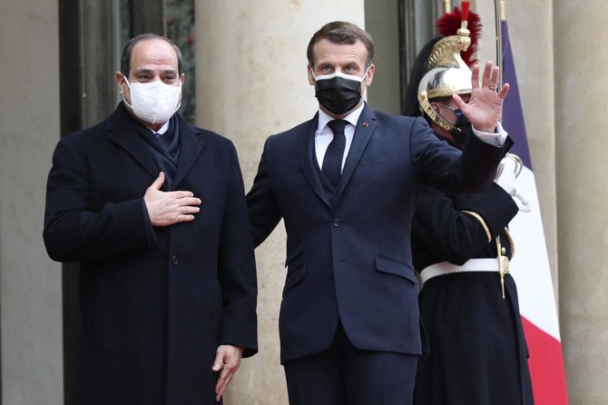 French President Emmanuel Macron, right, and Egyptian President Abdel-Fattah El-Siss gesture upon El-Sissi arrival at the Elysee palace, Monday, Dec. 7, 2020 in Paris. (AP)