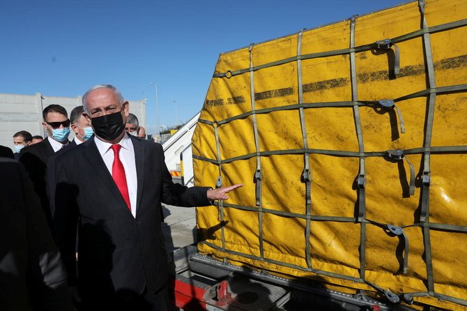 Israeli Prime Minister Benjamin Netanyahu attends the arrival of a DHL plane carrying a first batch of Pfizer/BioNTech COVID-19 vaccine at Ben Gurion Airport near Tel Aviv on Wednesday. (Reuters)