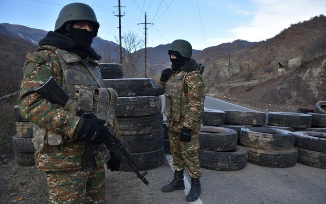Armenian soldiers stand guard at a checkpoint after a truce agreement in Nagorno-Karabakh. Syrians have detailed how they were duped into fighting in the conflict. (AFP/File