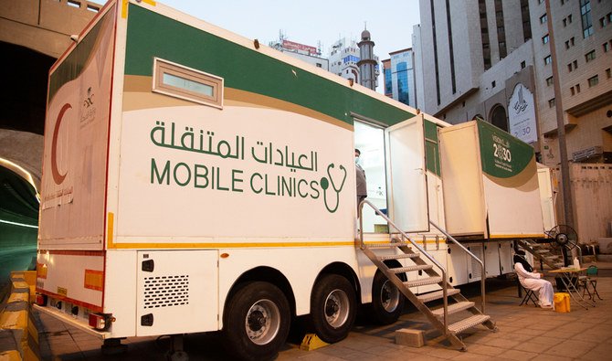 A medical staff member wearing a protective face mask and gloves sits outside of a mobile clinic in the holy city of Makkah, Saudi Arabia, in this file photo taken on April 2, 2020. (REUTERS)