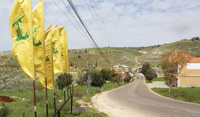 Hezbollah flags flutter at the entrance of Mays Al-Jabal village in Lebanon. Hezbollah use land routes to smuggle weapons and money to the Syrian regime. (Reuters)
