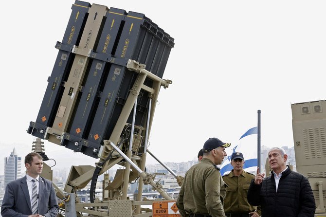 Israeli Prime Minister Benjamin Netanyahu stands near the Iron Dome interceptor system during a tour of a missile boat as part of his visit to a navy base in Haifa, Israel, February 12, 2019. (Reuters)
