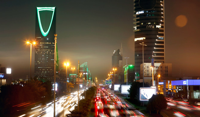 In this photo taken with a slow shutter speed, vehicles pass in front of the landmark Kingdom Tower in Riyadh, Saudi Arabia, Sept. 22, 2019. (AP)