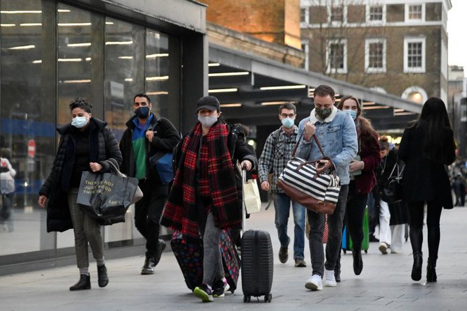Travellers walk outside of King's Cross station in London on December 20, 2020 as the British government imposed a stricter tiered set of restrictions amid the COVID-19 pandemic. (REUTERS/Toby Melville)