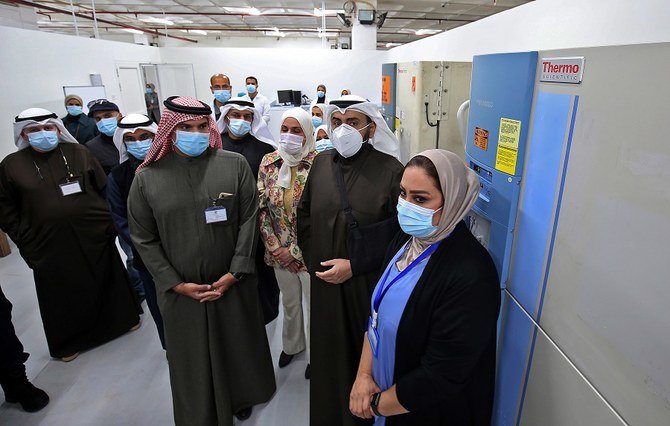 Kuwaiti health minister Sheikh Basel al-Sabah (2R) stands next to a refrigerator containing COVID-19 vaccines at the Kuwait vaccination center at the International Fairgrounds in Kuwait City on Dec. 23, 2020. (File/AFP)