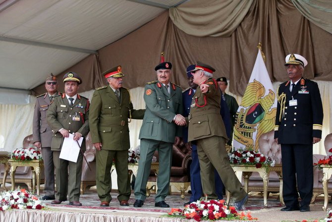 Libyan military commander Khalifa Haftar shakes hands with a comrade during Independence Day celebrations in Benghazi, Libya December 24, 2020. REUTERS/Esam Omran Al-Fetori