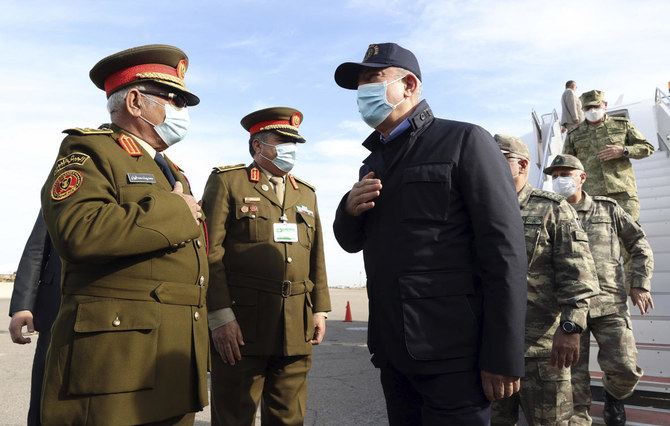 Turkey’s Defense Minister Hulusi Akar, center, and other top Turkish military commanders, right, greet Libyan commanders, at airport, in Tripoli, Libya, Saturday, Dec, 26, 2020. (AP)