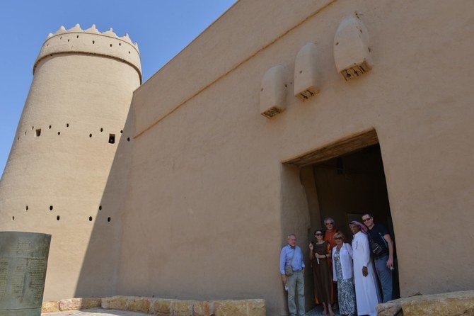 Polish tourists pose for a photograph as they visit the King Abdulaziz museum of Masmak in the old quarter of Riyadh on Oct. 17, 2019. (AFP)