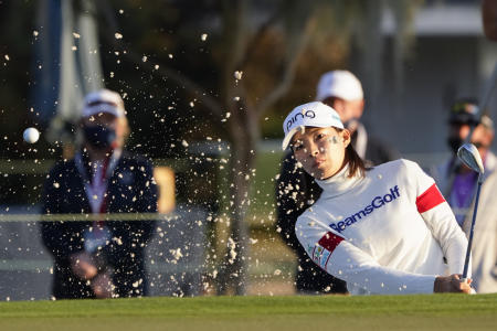 Hinako Shibuno, of Japan, hits out of a bunker near the 18th green during the third round of the US Women's Open golf tournament, on Saturday, Dec. 12, 2020, in Houston. (AP)