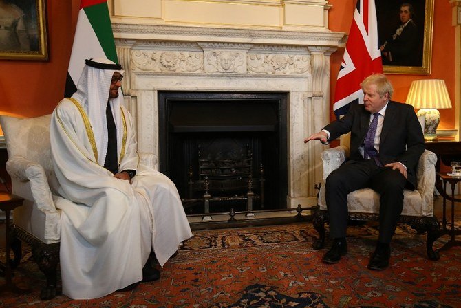 Britain's Prime Minister Boris Johnson (right) greets Abu Dhabi's Crown Prince Sheikh Mohammed bin Zayed Al Nahyan inside 10 Downing Street in central London on December 10, 2020. (File/AFP)