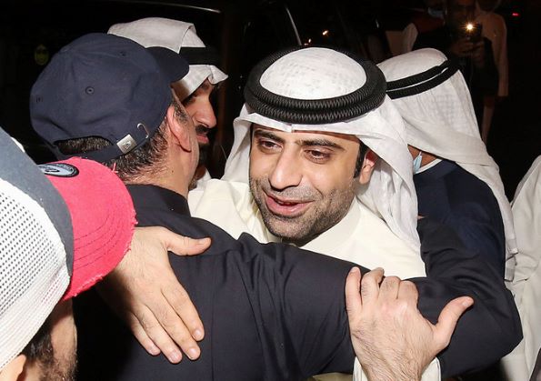 Kuwaiti candidate Hamad Rouheldeen celebrates with his supporters following the announcement of his victory in parliamentary election in Kuwait city on December 6, 2020.(AFP / YASSER AL-ZAYYAT)