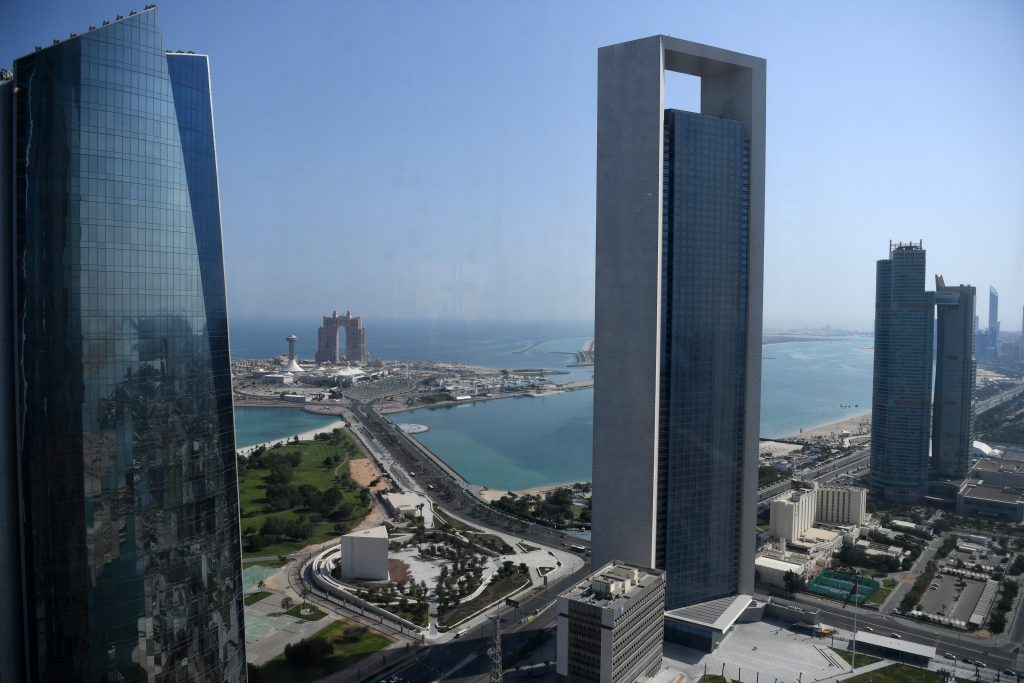 A general view taken on May 29, 2019 shows the sea front promenade in the Emirati capital Abu Dhabi with the ADNOC headquarters (Abu Dhabi National Oil Company) office complex (C) in the foreground on May 29, 2019. (AFP)