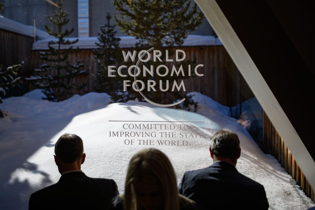 Participants check their messages during the World Economic Forum (WEF) annual meeting in Davos, on January 23, 2020. (AFP)