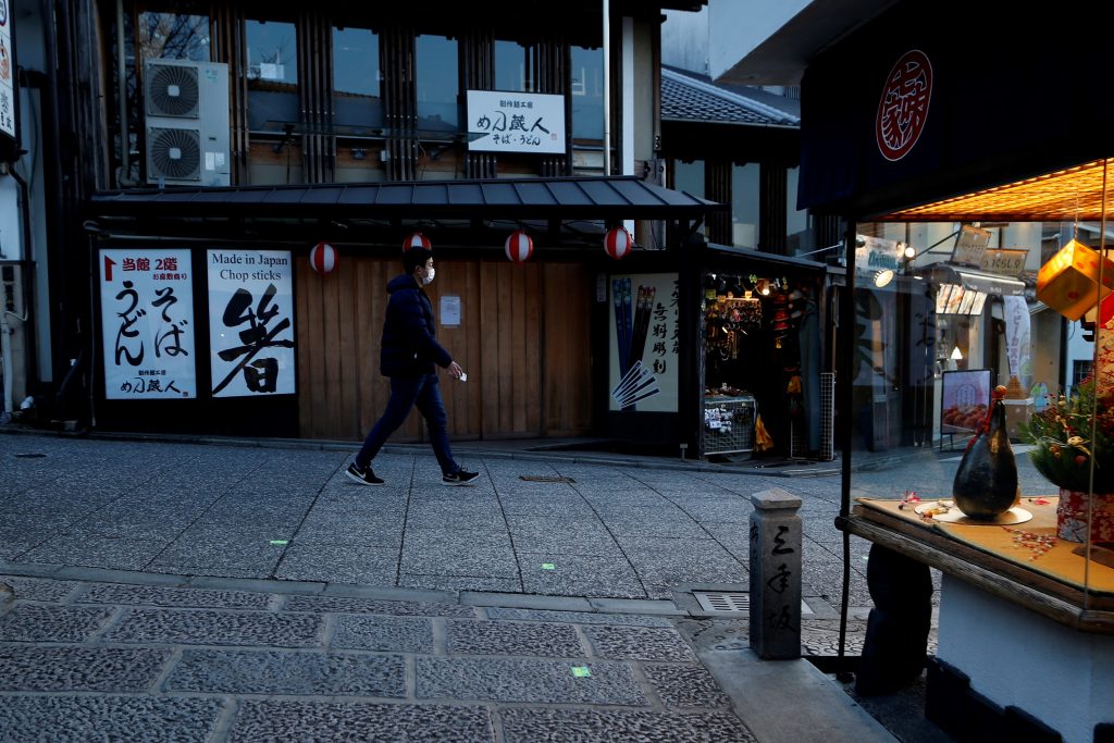 A man walks past a closed souvenir shop in a passageway to Kiyomizu-dera Temple, usually crowded with tourists, in Kyoto, Kyoto prefecture on January 14, 2021, a day after the country expanded the COVID-19 coronavirus state of emergency to seven more regions and tightened border restrictions. (AFP)