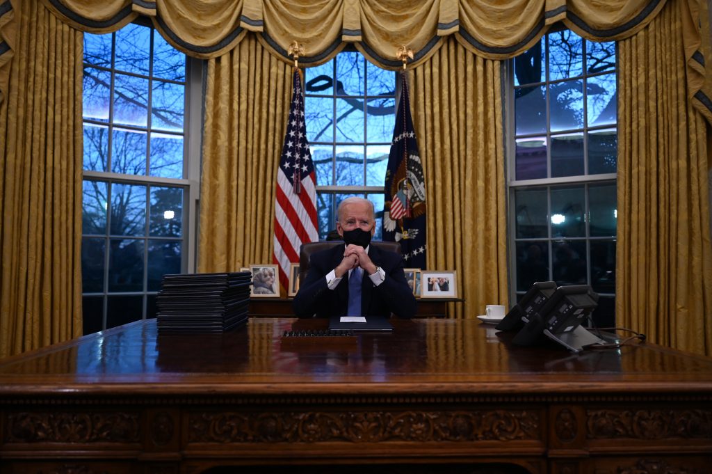 US President Joe Biden sits in the Oval Office at the White House in Washington, DC, after being sworn in at the US Capitol on January 20, 2021 (AFP)