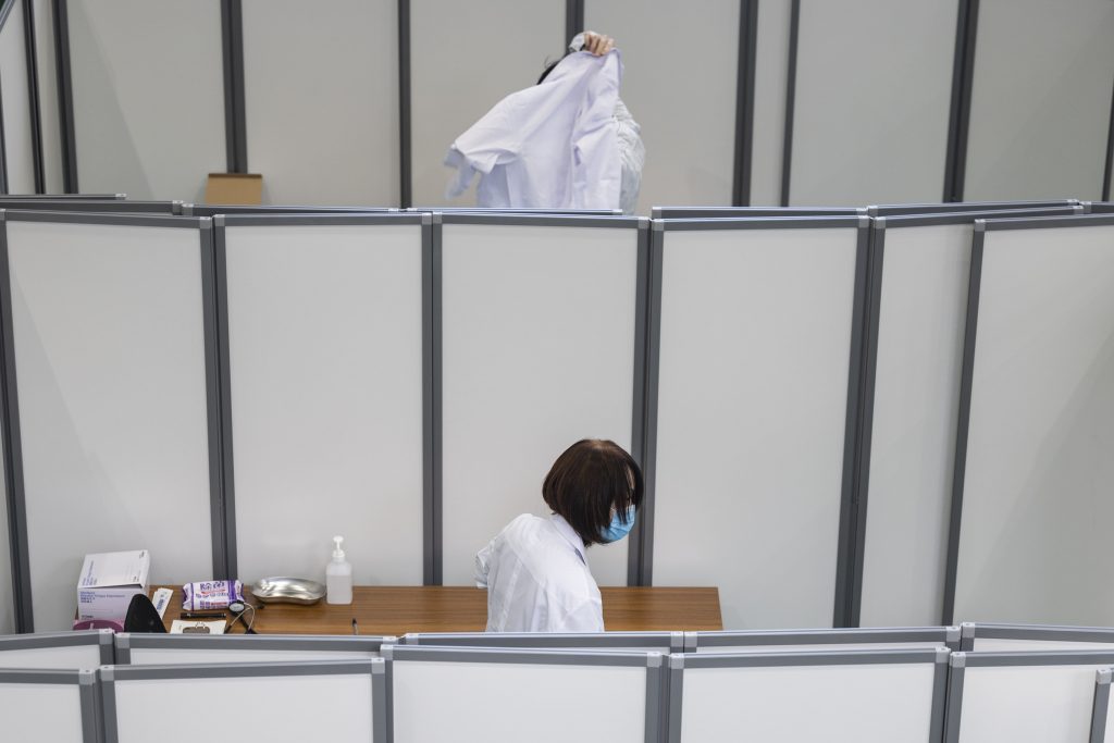 Doctors get ready in the partitioned rooms at the venue for a Covid-19 coronavirus vaccination drill at the Kawasaki City College of Nursing in Kawasaki on January 27, 2021. (AFP)