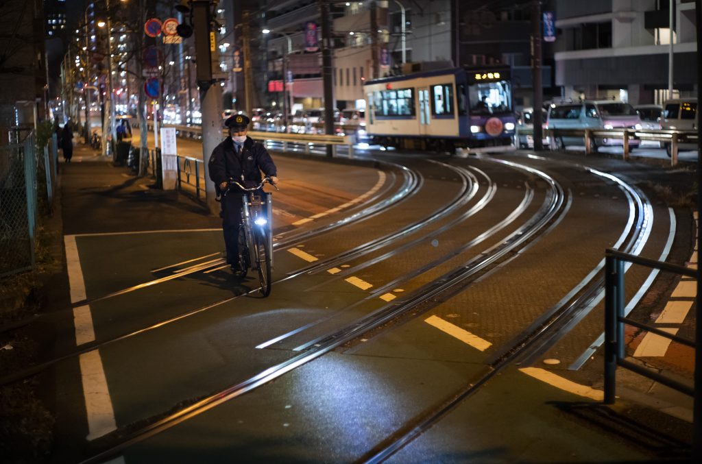 A police officer wearing a face mask patrols during the coronavirus state of emergency in Tokyo on Thursday, Jan. 14, 2021. (File Photo/AP)