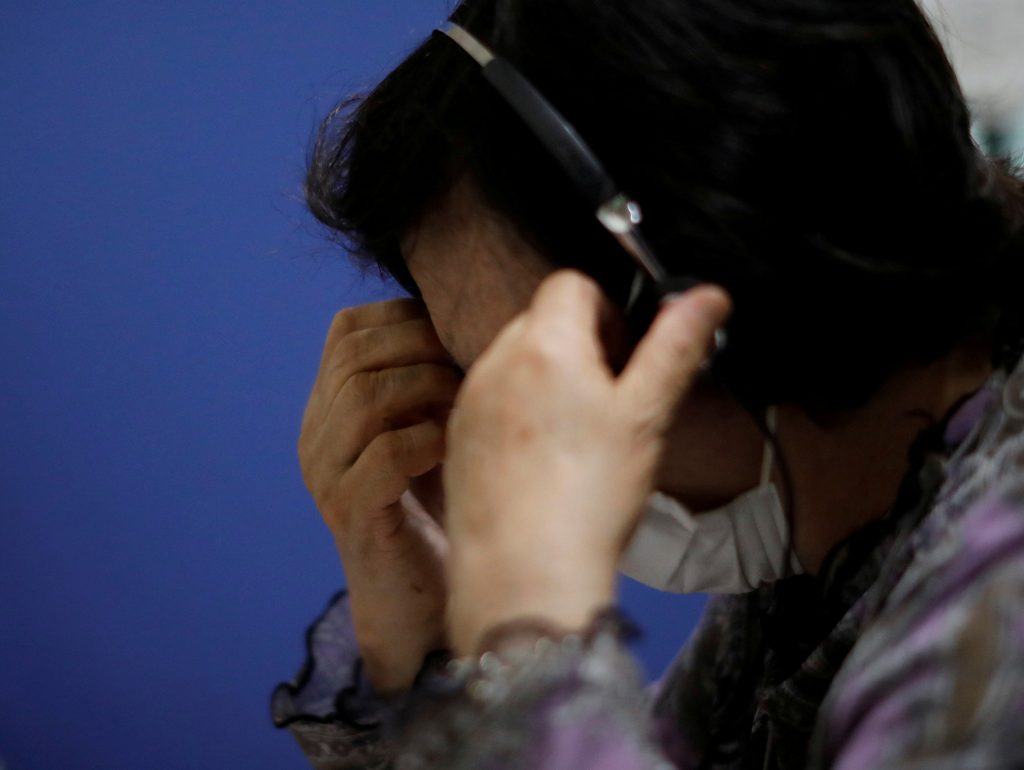 FILE PHOTO: A volunteer responds an incoming call at the Tokyo Befrienders call center, a Tokyo's suicide hotline center, during the spread of the coronavirus disease (COVID-19), in Tokyo, Japan May 26, 2020. Picture taken May 26, 2020. REUTERS/Issei Kato/File Photo