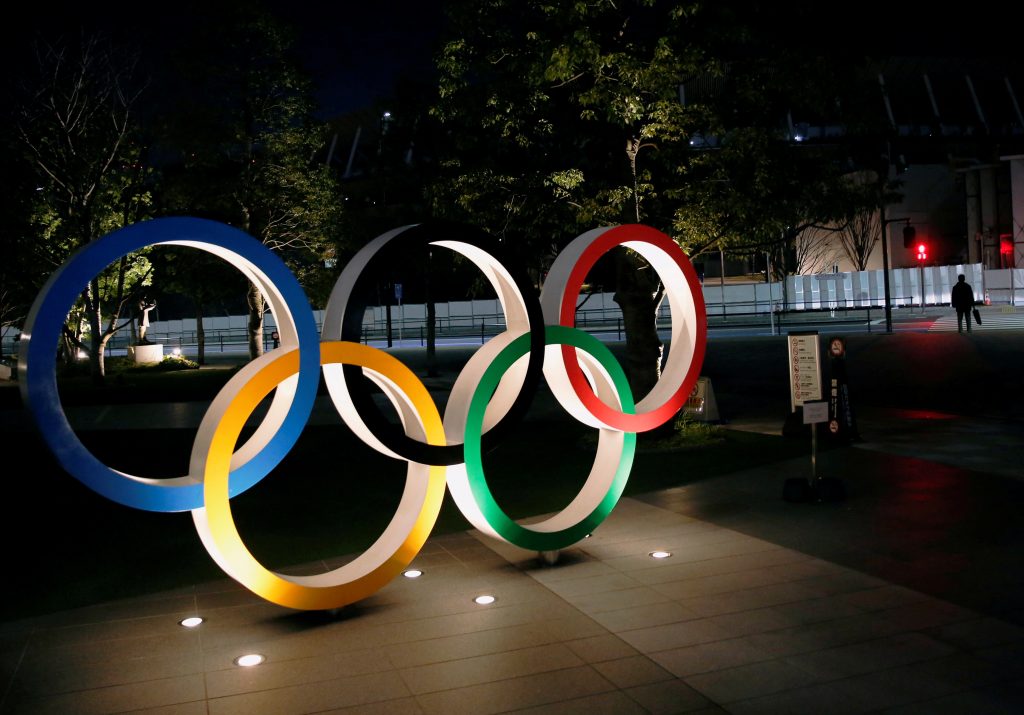 FILE PHOTO: The Olympic rings are illuminated in front of the National Stadium in Tokyo, Japan January 22, 2021. REUTERS