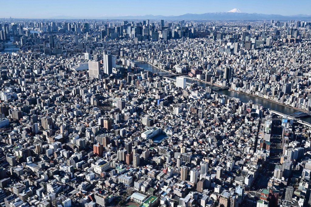 This picture shows a general view of the japanese capital city Tokyo, with the Mount Fuji, Japan's highest mountain at 3,776 meters (12,388 feet) on the top right on January 30, 2021. (AFP) 