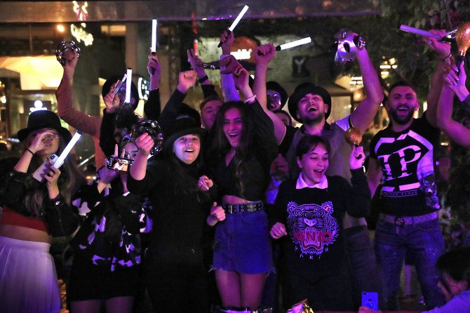 Lebanese people celebrate the New Year in Beirut, early Friday, Jan. 1, 2021. (AP)