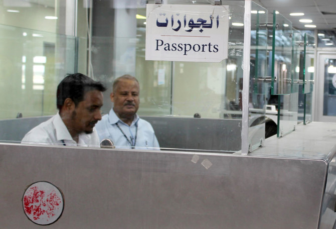 Passport control staff wait at their stations at the airport in Yemen's southern city of Aden on January 3, 2021, as activity resumes after explosions rocked the building on December 30, killing or injuring dozens of people. (AFP)