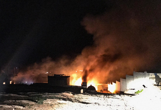 Fire and smoke plumes rise at the scene of an explosion in the Lebanese Hermel governorate in the eastern Bekaa valley, near the Syrian border, on January 3, 2021. (AFP)