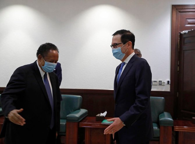 Sudanese Prime Minister Abdullah Hamdok, right, welcomes US Treasury Secretary Steven Mnuchin to the Cabinet Building, in Khartoum, Sudan, Wednesday, Jan. 6, 2021. (AP)