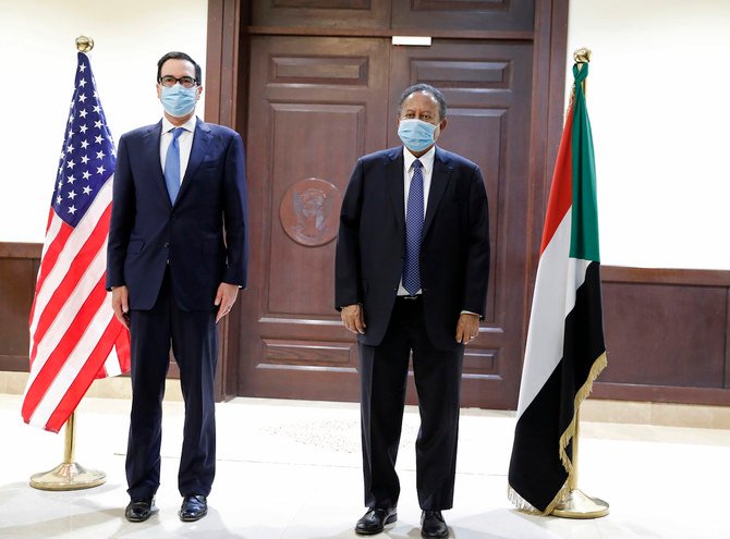 Sudanese Prime Minister Abdullah Hamdok, right, welcomes US Treasury Secretary Steven Mnuchin to the Cabinet Building, in Khartoum, Sudan, Wednesday, Jan. 6, 2021. (AP)