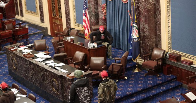 Protesters breached the Capitol, marched through Congress and sat in the Speaker’s chair during a special session to certify Biden’s victory. (AFP)