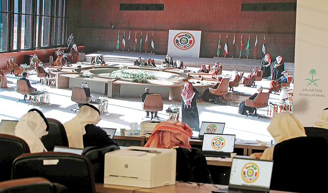 A general view of the summit on a screen at the media center in AlUla. (Reuters)