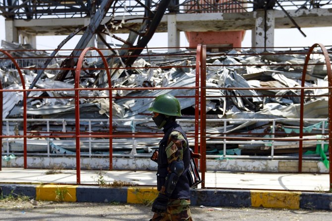 A fighter loyal to Houthi militants stands guard in the capital Sanaa on Sept. 24, 2020, during a ceremony by the militia to collect cash, food and other donations for their fighters. (File/AFP)