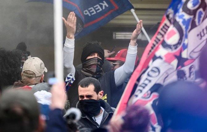 U.S. Capitol In the gravest assault on the symbol of American democracy in more than 200 years, rioters forced their way past metal security barricades, broke windows and scaled walls to fight their way into the Capitol. (AFP)with guns drawn stand near a barricaded door as protesters try to break into the House Chamber at the U.S. Capitol on Wednesday, Jan. 6, 2021, in Washington. (AP Photo/Andrew Harnik)