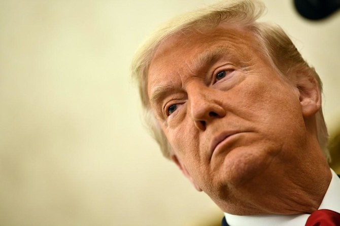 President Donald Trump speaks before awarding the Presidential Medal of Freedom to retired football coach Lou Holtz in the Oval Office of the White House in Washington, DC, on Dec. 3, 2020. (File/AFP)