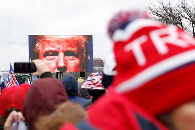 US President Donald Trump is seen on a screen speaking to supporters during a rally to contest the certification of the 2020 US presidential election results by the US Congress, in Washington. (Reuters/File Photo)