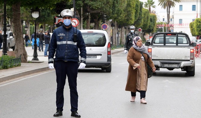 Police officers check vehicles at Habib Bourguiba Avenue in Tunis on March 24, 2020. (AFP)