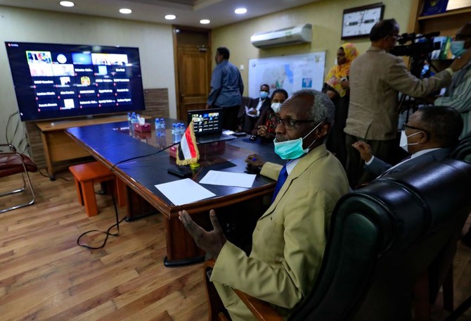 Sudan's Minister of Irrigation and Water Resources Yasser Abbas (L) and Minister for Foreign Affairs are pictured during a video conference meeting with their Egyptian and Ethopian counterparts in Khartoum on January 10, 2020. (AFP)