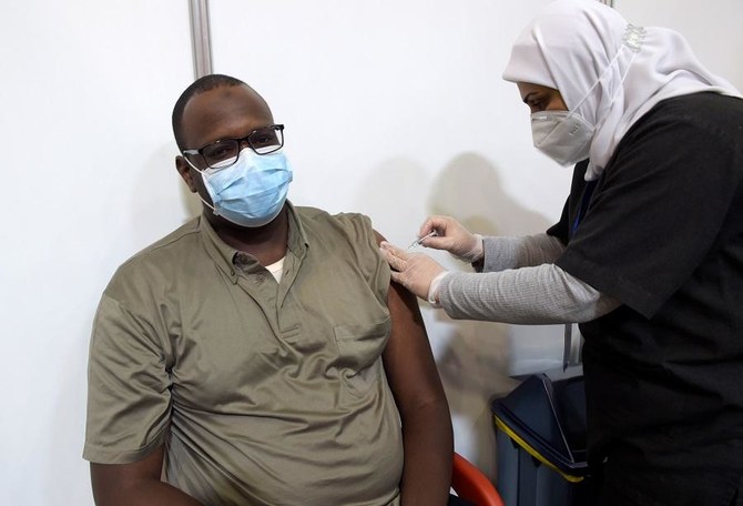 A man receives a COVID-19 vaccine at the Bahrain International Exhibition and Convention Center in the capital Manama, on December 24, 2020. (File/AFP)