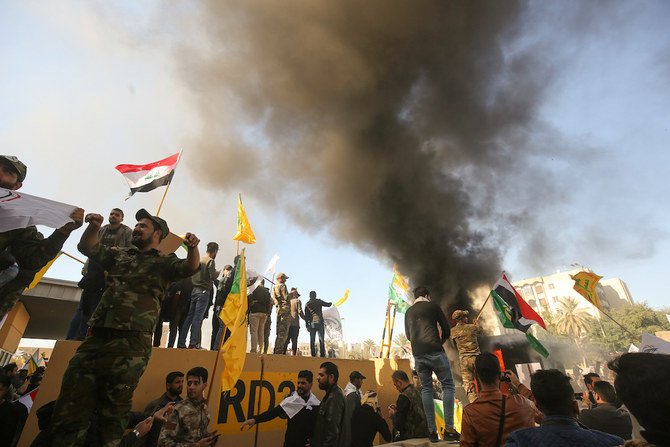 Members of the Iraqi pro-Iranian Hashed al-Shaabi group and protesters set ablaze a sentry box in front of the US embassy building in the capital Baghdad. (AFP/File Photo)