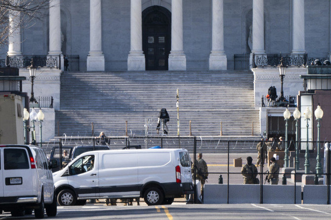 Military personnel work behind anti-scaling security fencing and razor wire on Jan. 16, 2021, in Washington, as security is increased ahead of the inauguration of President-elect Joe Biden and Vice President-elect Kamala Harris. (AP Photo/Jacquelyn Martin)