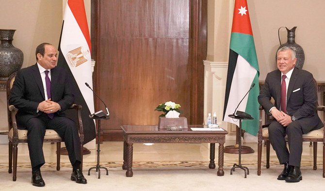 A handout picture released by the Jordanian Royal Palace on January 18, 2021 shows Jordanian King Abdullah II (R) welcoming Egypt's President Abdel Fattah al-Sisi in the capital Amman. (AFP)