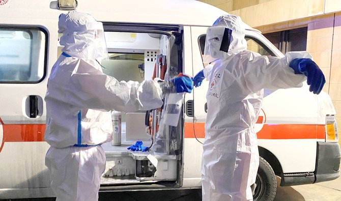 A volunteer from Lebanese Red Cross sanitizes his colleague at Rizk Hospital in Beirut. (Reuters)