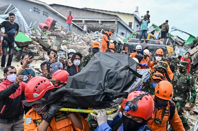 At least 56 people killed and 820 injured in a 6.2 quake hitting Sulawesi leaving 15,000 people displaced (AFP)