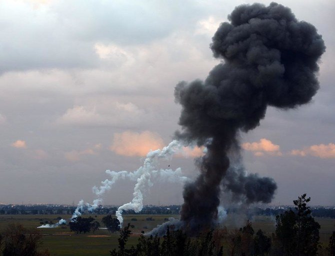 A picture taken on February 10, 2015 in Tripoli shows smoke billowing after members of the Military College of Engineering of Misrata destroyed unexploded munitions that were found around the Libyan international airport after weeks of fighting. UNSMIL, the United Nations Support Mission in Libya, said in a statement on February 9, 2015. (File/AFP)