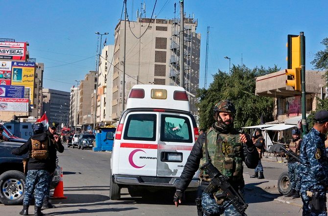 Above, the scene of a twin suicide bombing which killed nearly 30 people on a bustling commercial street in the heart of Baghdad on January 21, 2021. (AFP)