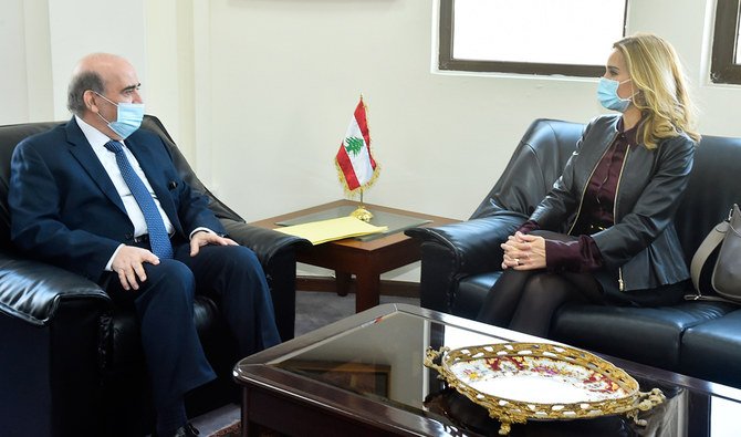 In this photo released by Lebanon's official government photographer Dalati Nohra, Lebanese Foreign Minister Charbel Wehbi, left, meets with Switzerland's ambassador to Lebanon Monika Schmutz Kirgöz, right, in Beirut, Lebanon, Monday, Jan. 25, 2021. (AP)