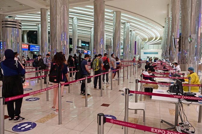 Tourists wait in line to get a medical screening upon arrival at Teminal 3 at Dubai airport on July 8, 2020. (File/AFP)